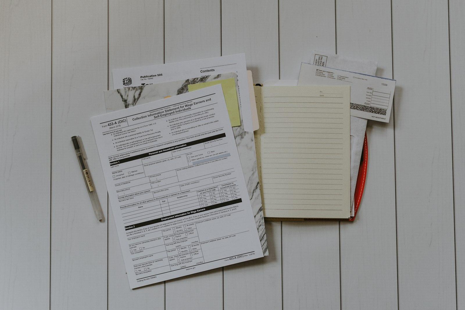 A flat lay of forms and papers on a desk